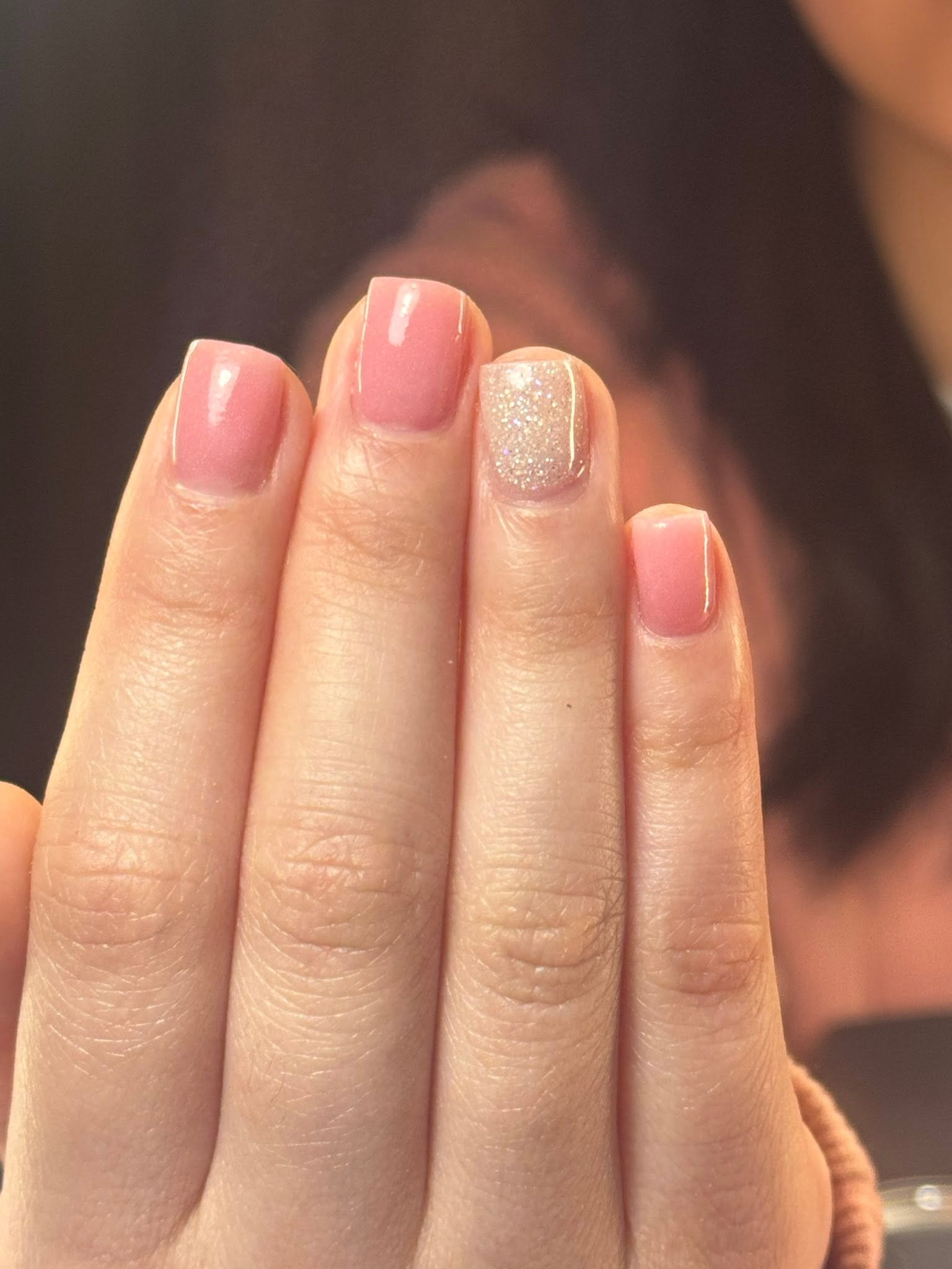 Blush pink glossy nails with a glitter accent nail