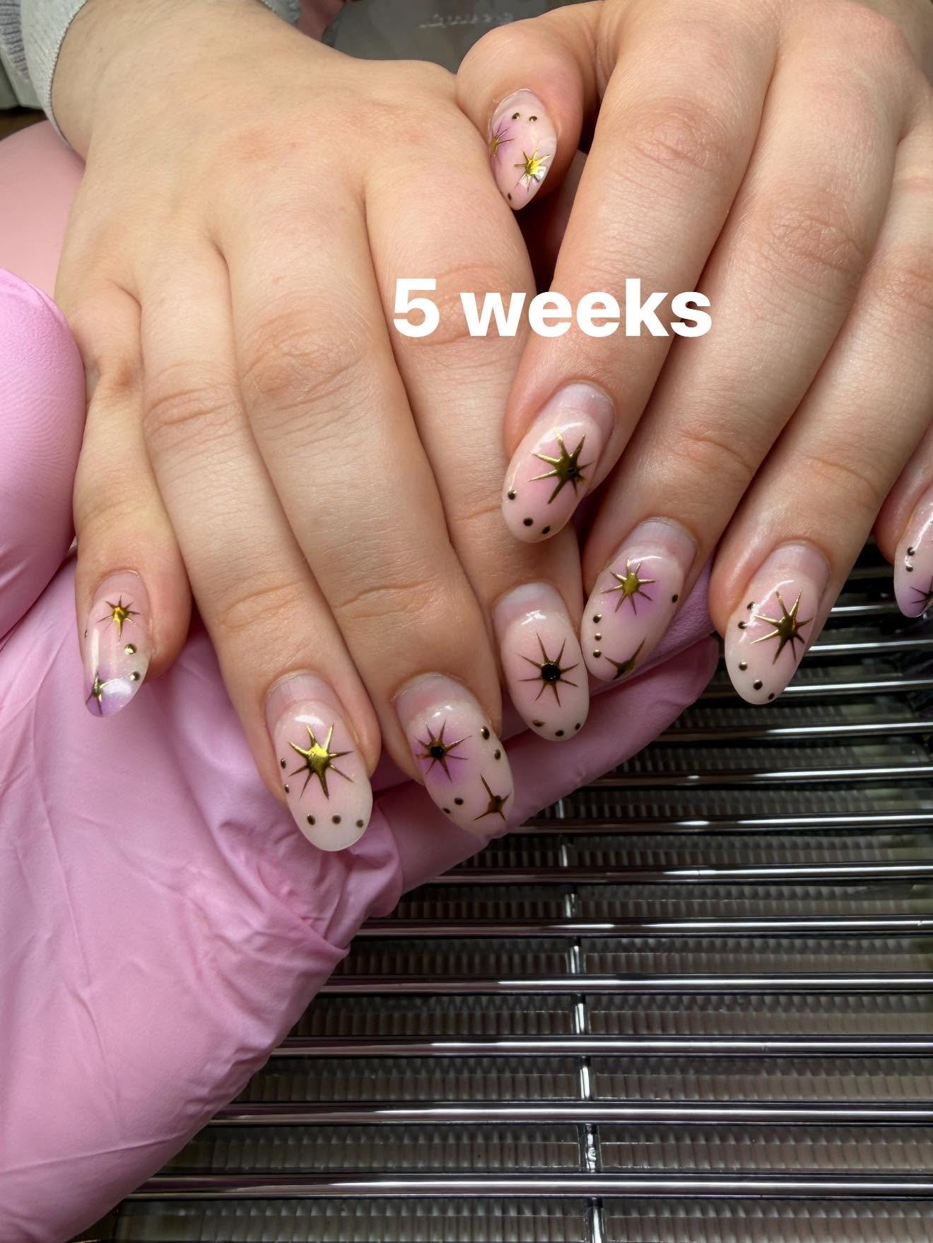 Nude nails with gold starburst nail art