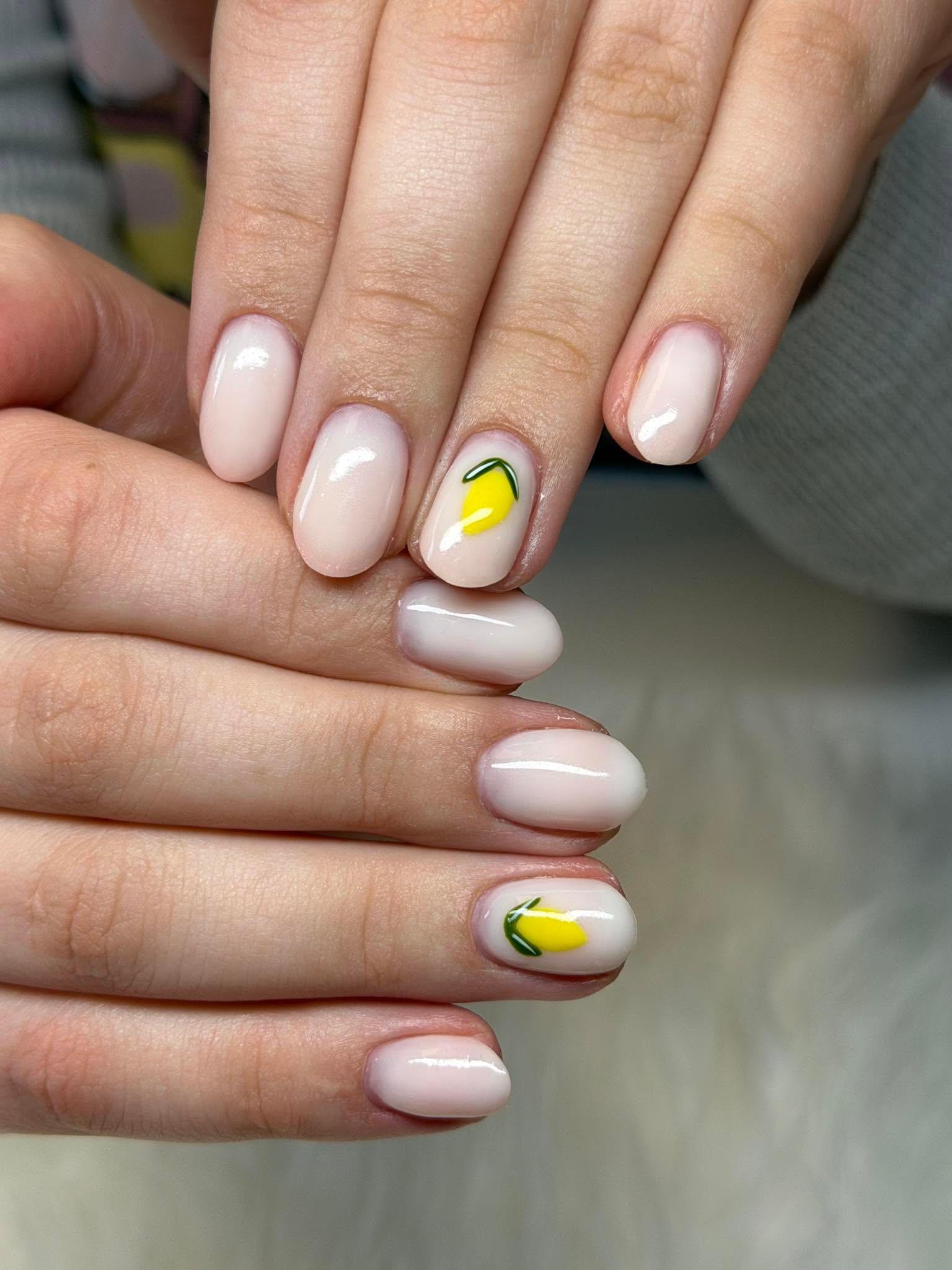 Nude nails with a fresh lemon accent design