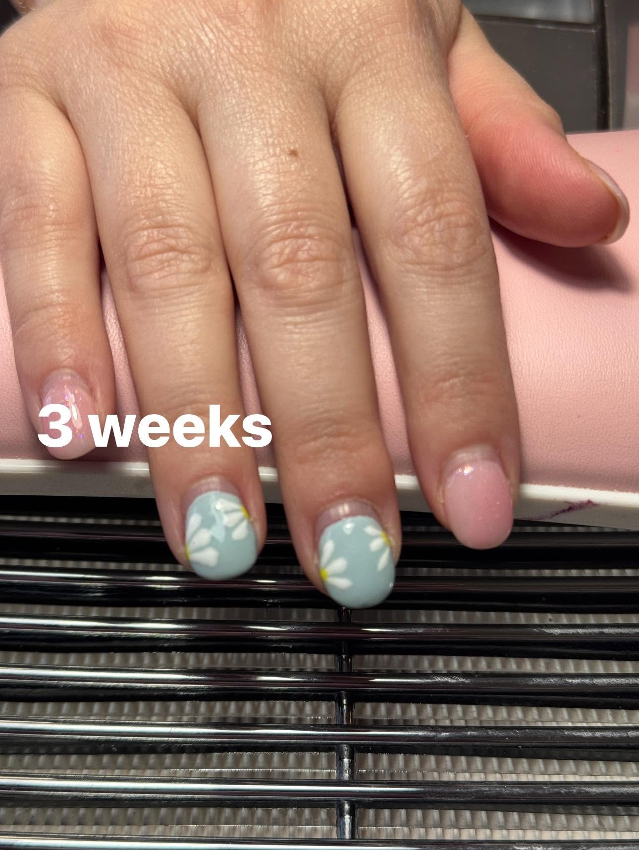 Mint green nails with painted white daisy accents