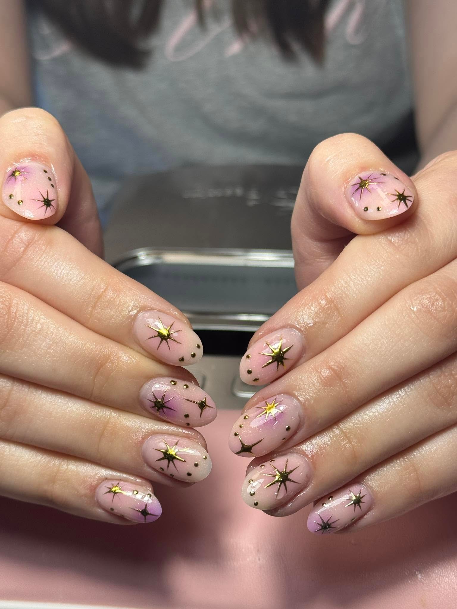 Nude nails with hand-painted gold star constellation design