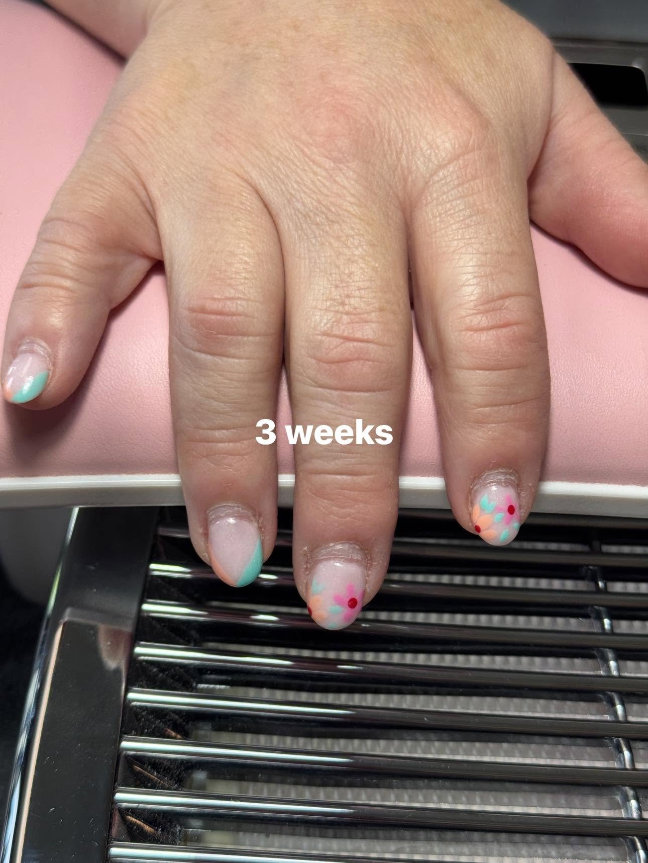 Pastel mint and peach nails with floral accent design