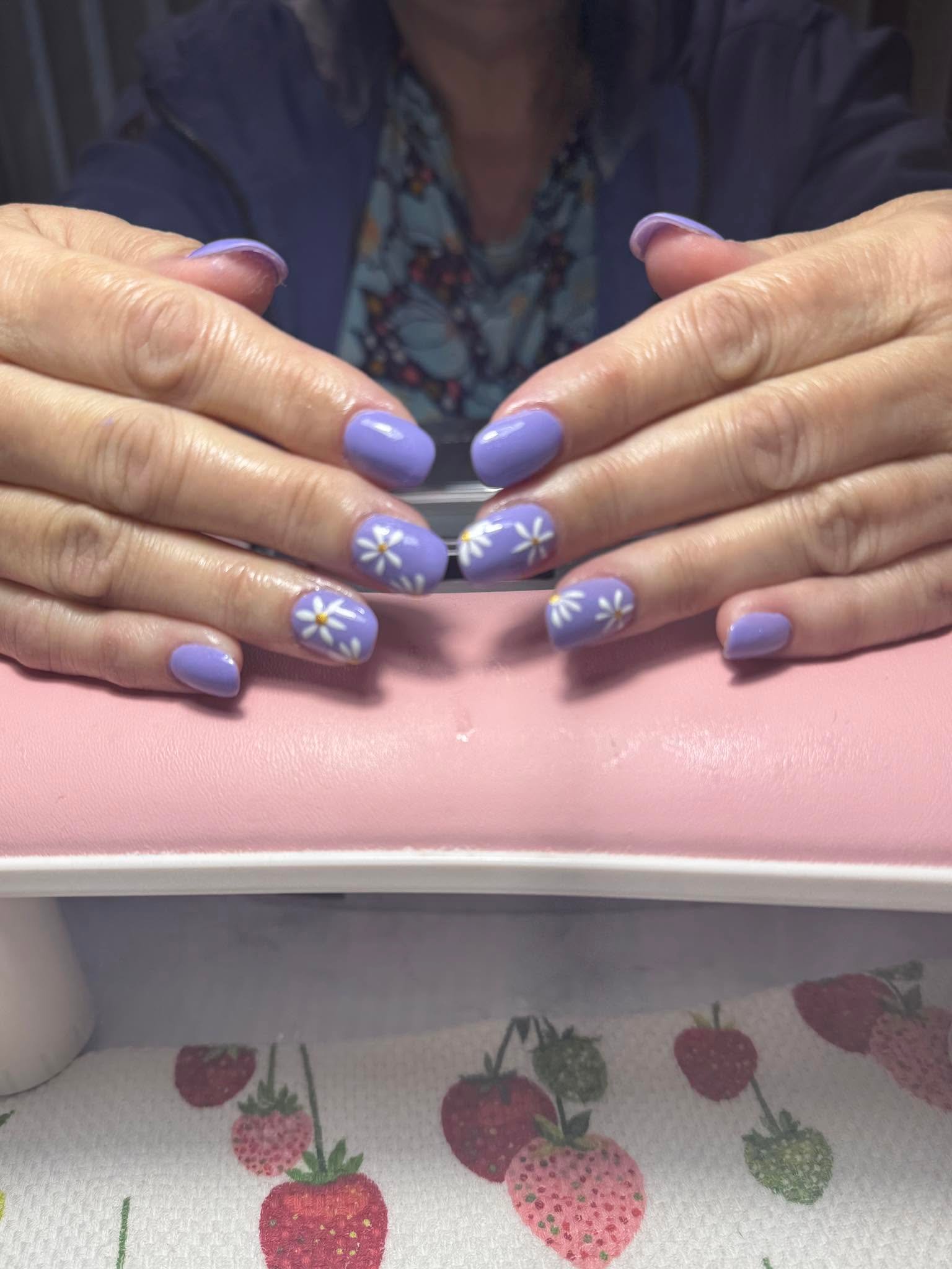 Lilac gel manicure with hand-painted white daisy accents