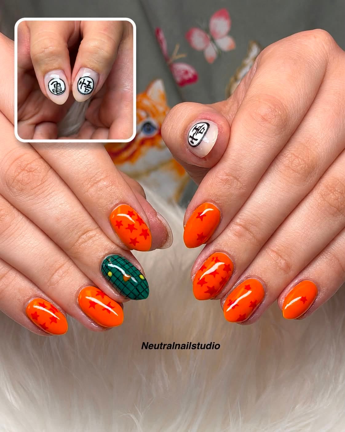 Orange nail art with red stars and character design