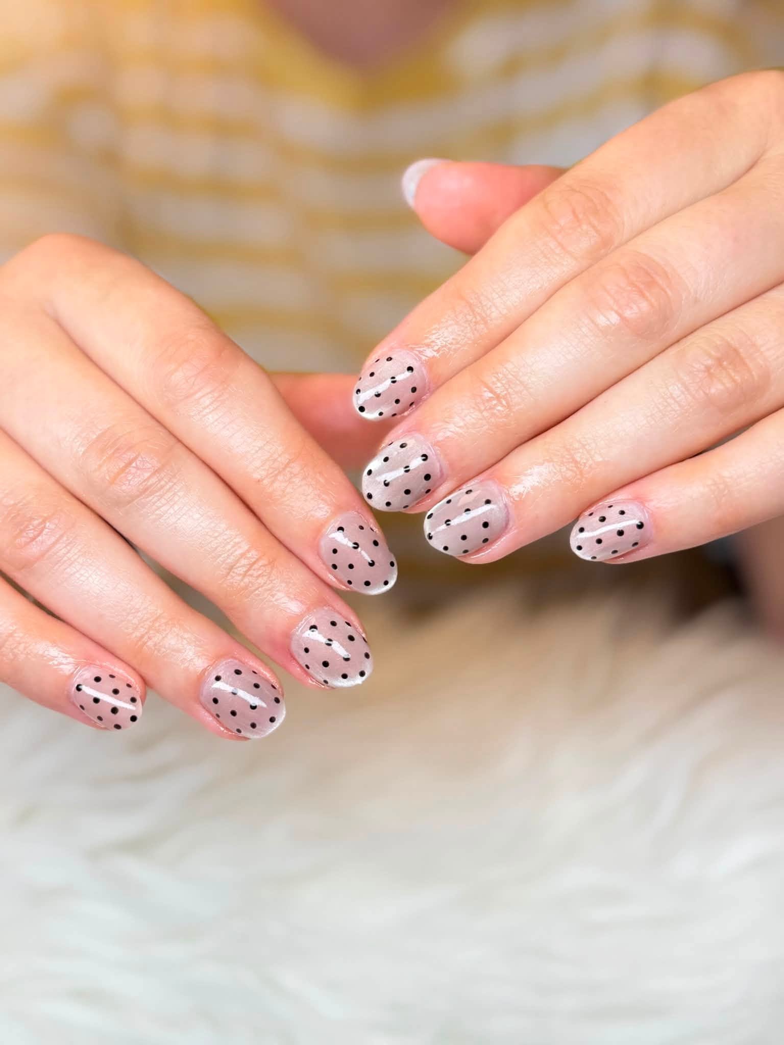 Mauve manicure with black polka dots