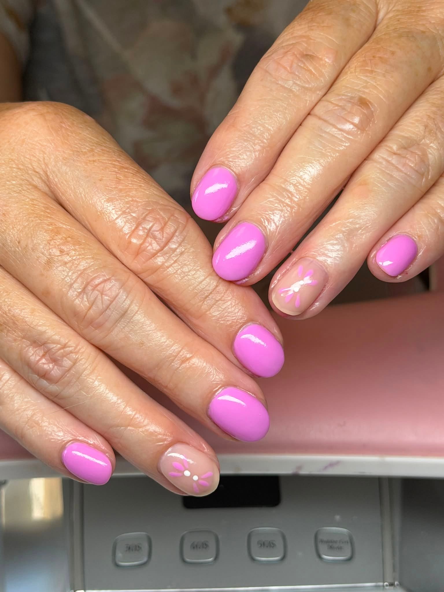 Pink manicure with painted flower accent