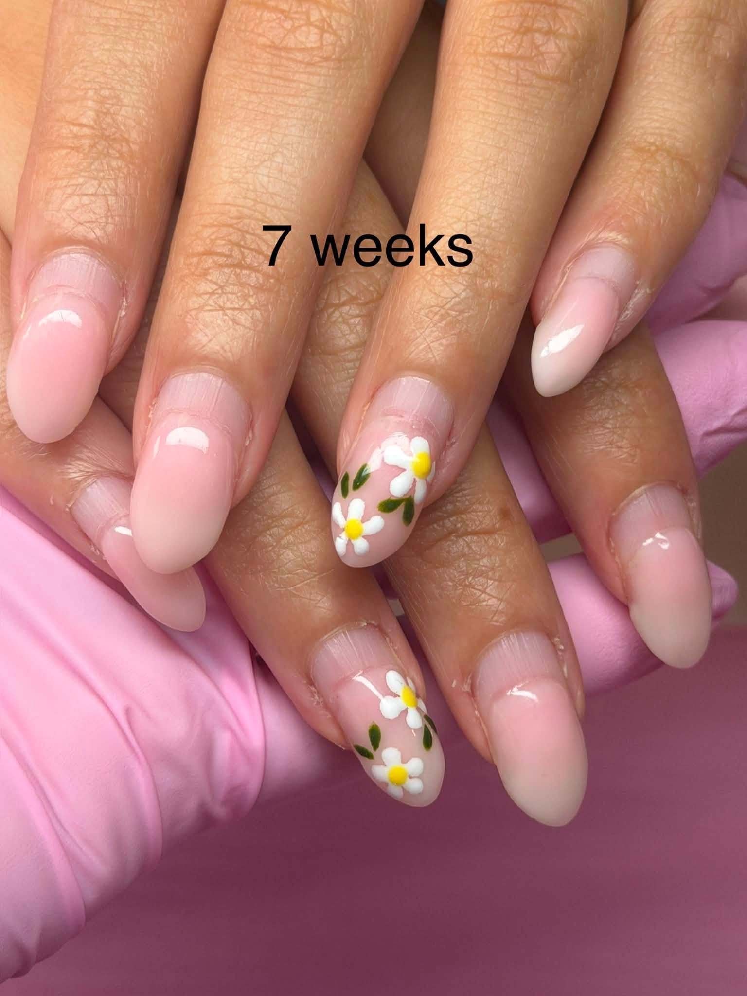 Nude manicure with painted daisy accent