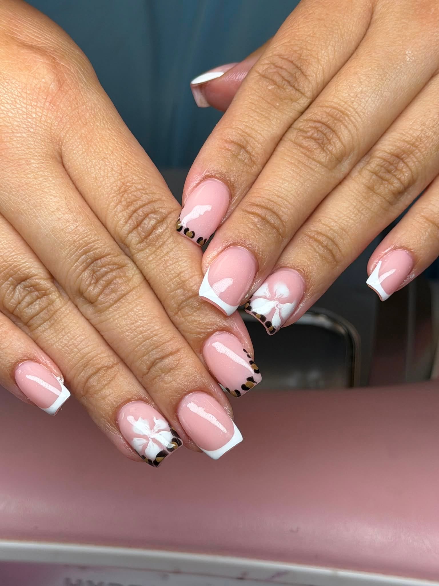 Nude French manicure with leopard print accents